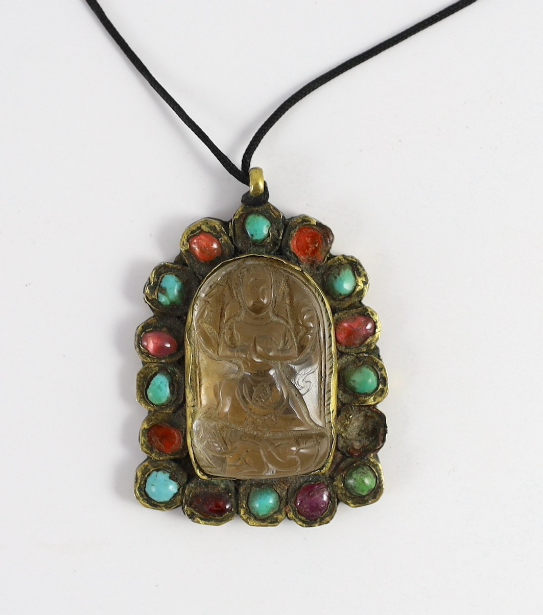 A Tibetan rock crystal and gem set pendant, 19th century, 5.8cm including suspension loop, slight damage